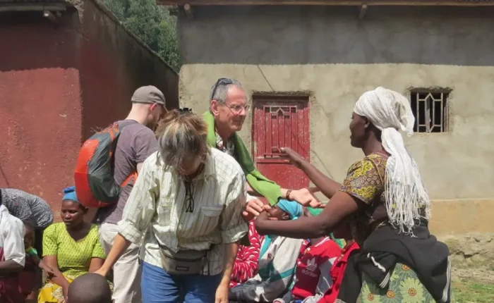 Volunteers working with local community members in Rwanda, engaging in educational activities and cultural exchanges.