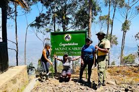 A panoramic view of Mount Kabuye’s rugged terrain, featuring rocky trails and striking peaks under a clear sky.